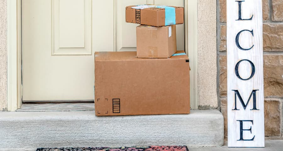 Boxes by the door of a residence with a welcome sign in Omaha